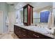 Bathroom boasts granite countertops and dark wood cabinets at 33448 N 69Th Pl, Scottsdale, AZ 85266