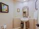 Elegant powder room with pedestal sink and decorative mirror at 33448 N 69Th Pl, Scottsdale, AZ 85266