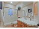 Clean bathroom with shower, tiled walls, and wood vanity at 33448 N 69Th Pl, Scottsdale, AZ 85266