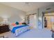 Bright bedroom featuring a king-size bed and built-in shelving at 33448 N 69Th Pl, Scottsdale, AZ 85266