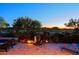 Tranquil patio with water feature, lighting and golf course view at 33448 N 69Th Pl, Scottsdale, AZ 85266