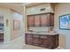 Custom wet bar with granite countertop and wood cabinets at 33448 N 69Th Pl, Scottsdale, AZ 85266