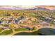 Aerial view showcasing a luxurious community near a golf course and lake at 3374 E Virgil Dr, Gilbert, AZ 85298