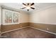 Inviting bedroom with neutral tones, a ceiling fan, and a bright window at 3374 E Virgil Dr, Gilbert, AZ 85298