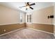 Comfortable bedroom with a ceiling fan and plantation shutters at 3374 E Virgil Dr, Gilbert, AZ 85298