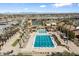 Community pool with lounge chairs, palm trees, lane lines for swimming and a slide at 3374 E Virgil Dr, Gilbert, AZ 85298