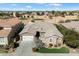 Stunning home with a neutral color palette, stone accents, and a well-manicured lawn next to a golf course at 3374 E Virgil Dr, Gilbert, AZ 85298