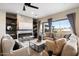 Cozy living room with a modern fireplace, plush seating, and natural light from large windows at 3374 E Virgil Dr, Gilbert, AZ 85298