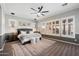 Spacious main bedroom boasts a ceiling fan and plantation shutters, a rug and neutral paint at 3374 E Virgil Dr, Gilbert, AZ 85298