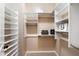 Bright walk-in closet with custom white shelving and carpeted floor at 3374 E Virgil Dr, Gilbert, AZ 85298