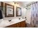 Bathroom with double vanity, tub shower combo and decorative mirrors at 3471 E Powell Way, Gilbert, AZ 85298