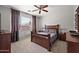 Spacious bedroom with a ceiling fan and wood furniture at 3471 E Powell Way, Gilbert, AZ 85298