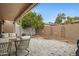 Private backyard patio with seating area and mature tree for shade at 3510 E Hampton Ave # 3, Mesa, AZ 85204