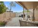 Relaxing stone patio with covered seating area, wicker furniture, and a grill at 3510 E Hampton Ave # 3, Mesa, AZ 85204