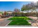 Landscaped backyard with artificial turf and seating area at 3543 W Magellan Dr, Anthem, AZ 85086