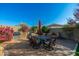 Outdoor dining area with stonework and colorful plants at 3543 W Magellan Dr, Anthem, AZ 85086