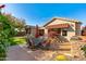 Spacious backyard patio with seating area, built-in grill, and lush landscaping at 3543 W Magellan Dr, Anthem, AZ 85086