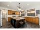 Island kitchen with granite counters and wood cabinets at 3543 W Magellan Dr, Anthem, AZ 85086