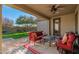 Relaxing covered patio with seating and view of the yard at 3543 W Magellan Dr, Anthem, AZ 85086