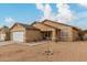 Single story home with a white garage door and desert landscaping at 3640 W Melinda Ln, Glendale, AZ 85308