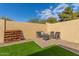 Relaxing patio area with fire pit, seating and artificial turf at 3640 W Melinda Ln, Glendale, AZ 85308