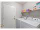 Functional laundry room with washer, dryer, and shelving at 3645 E Sheffield Rd, Gilbert, AZ 85296