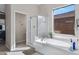 Bright bathroom featuring a soaking tub, glass shower and large window providing natural light at 40325 N Graham Way, Anthem, AZ 85086