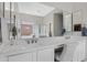 Bright bathroom with double sinks, decorative mirror, and a large window that provides natural light at 40325 N Graham Way, Anthem, AZ 85086