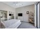 Clean bedroom with mirrored closet doors, a simple bed frame, and neutral decor creating a serene space at 40325 N Graham Way, Anthem, AZ 85086