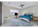 Bright bedroom featuring neutral walls, ceiling fan, and a large window that provides natural light at 40325 N Graham Way, Anthem, AZ 85086