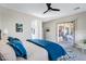 Bright, airy bedroom with ceiling fan, carpeting, and sliding door access to the covered patio at 40325 N Graham Way, Anthem, AZ 85086