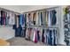 Spacious walk-in closet with ample hanging space and shelving for shoes and accessories at 40325 N Graham Way, Anthem, AZ 85086