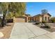 Beautiful home with a large driveway leading to a spacious two car garage at 40325 N Graham Way, Anthem, AZ 85086