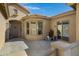 Inviting front patio featuring a stylish door, arched entryway and neutral color palette at 40325 N Graham Way, Anthem, AZ 85086