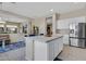 Bright kitchen with a center island, stainless steel refrigerator, and an open floor plan at 40325 N Graham Way, Anthem, AZ 85086