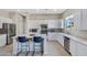 Well-lit kitchen with white cabinetry, stainless steel appliances, and a functional center island at 40325 N Graham Way, Anthem, AZ 85086