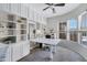 Bright home office featuring modern desk, window views, and white built-in shelves and cabinets at 40325 N Graham Way, Anthem, AZ 85086