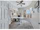 Bright home office with modern desk, wall of windows and white built-in shelves and cabinets at 40325 N Graham Way, Anthem, AZ 85086