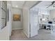 Hallway view into bright home office with a large desk and white built-in cabinets and shelves at 40325 N Graham Way, Anthem, AZ 85086