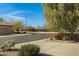 View of the quiet street with green landscaping, and a community playground at 40325 N Graham Way, Anthem, AZ 85086