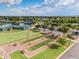 Aerial of community bocce ball and tennis courts under sunny skies at 41929 W Springtime Rd, Maricopa, AZ 85138