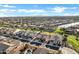 Aerial view showcasing houses, lake, and mountain views at 41929 W Springtime Rd, Maricopa, AZ 85138