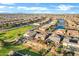 Aerial view of homes surrounding a lake in a community at 41929 W Springtime Rd, Maricopa, AZ 85138