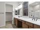 Elegant bathroom with double sinks, large mirror, and walk-in shower at 41929 W Springtime Rd, Maricopa, AZ 85138