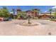 Exterior shot showcasing the grand clubhouse with its circular driveway and elegant fountain, highlighting the community's upscale amenities at 41929 W Springtime Rd, Maricopa, AZ 85138