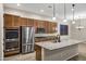 Modern kitchen with large island, stainless steel appliances, and granite countertops at 41929 W Springtime Rd, Maricopa, AZ 85138