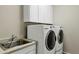 Laundry room with washer, dryer, and utility sink at 41929 W Springtime Rd, Maricopa, AZ 85138