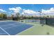 View of the community's tennis courts and shaded benches under a bright sky at 41929 W Springtime Rd, Maricopa, AZ 85138