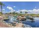 Scenic view of a community water feature with rocks, a small waterfall, and lush landscaping at 41929 W Springtime Rd, Maricopa, AZ 85138