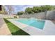 Backyard pool featuring a waterfall feature and lush artificial grass, creating a serene and low-maintenance outdoor space at 4201 N 18Th Pl, Phoenix, AZ 85016